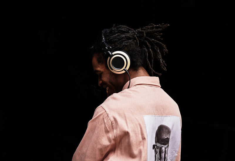 Model listening to music on Status Audio CB-1 headphones